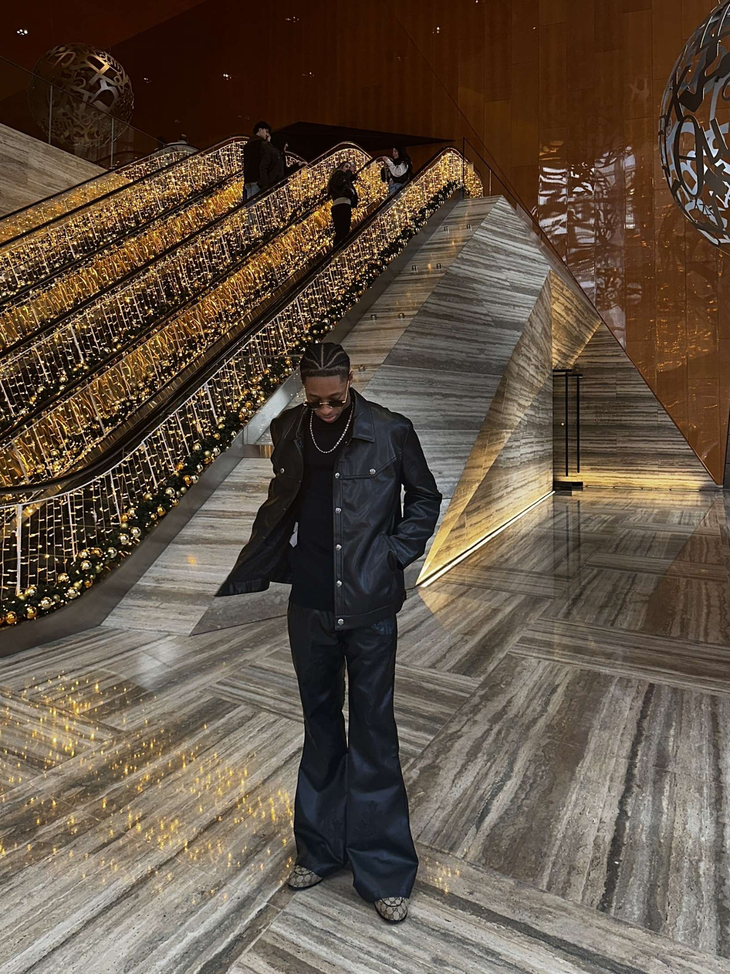 Rinvel Rousseau Jr. in a marble and gold lobby